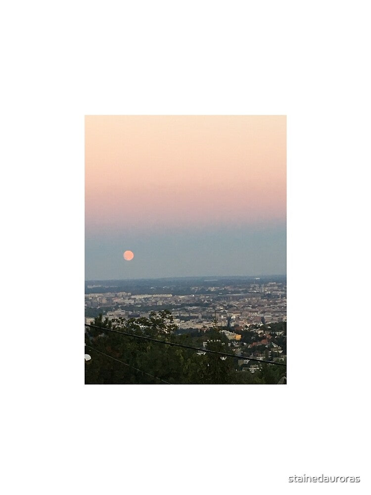 full pink moon during sunset over city by stainedauroras