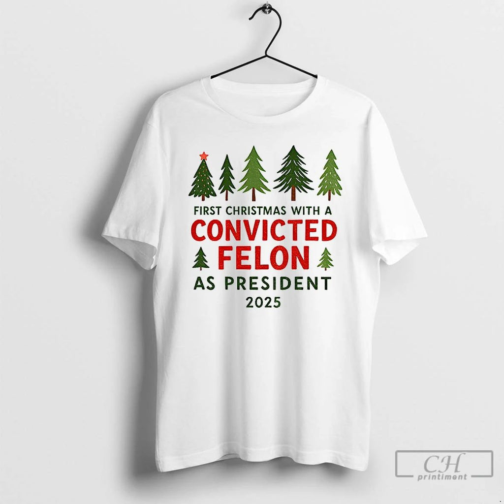 Premium Christmas Tree First Christmas With A Convicted Felon As President 2025 T Shirts Unisex